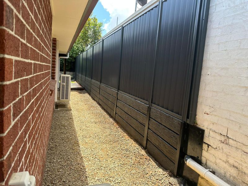 11 black colorbond fence on black concrete sleepers