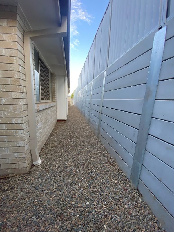 8 concrete sleeper retaining wall with high colorbond fence